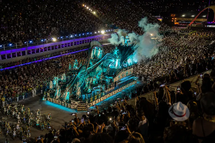 A samba school float lit up on parade night at the Sambadrome
