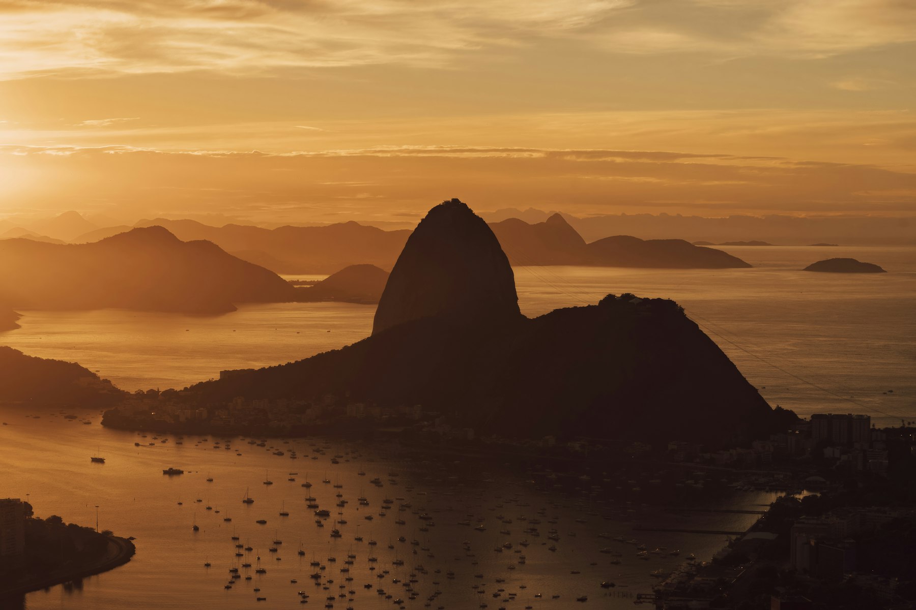 Sugarloaf Mountain silhouetted at sunset over Guanabara Bay, Rio de Janeiro